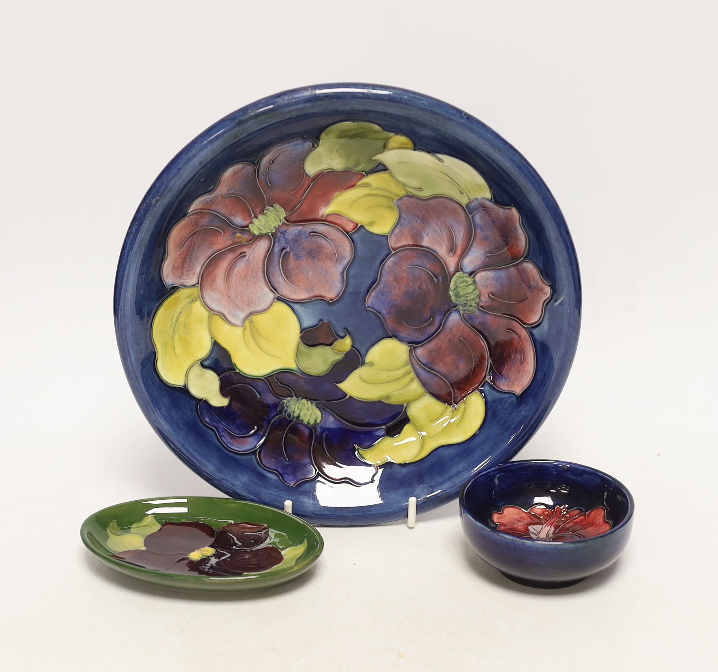 A Moorcroft Pansy plate, pin dish and a small bowl, 22cm in diameter